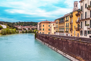 Naklejka na ściany i meble Verona, Italy - June 25, 2017: Scenery with Adige River in Verona with old historical buildings, Italy, Postcard.