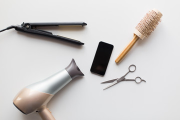 smartphone, scissors, hairdryer, iron and brush