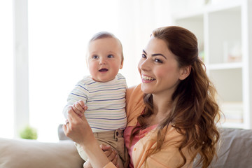 happy young mother with little baby at home
