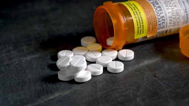 Macro video of Oxycodone Opioid tablets on slate table