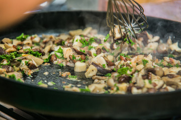 The chef in the kitchen prepares healthy food with vegetables.
