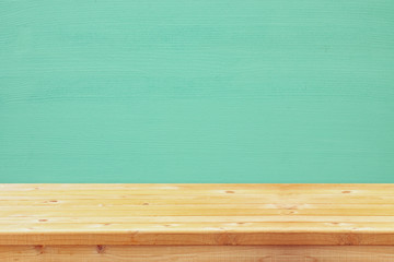 Empty table in front of blue wooden background. For product display montage