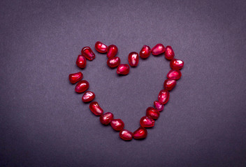 Fresh pomegranate macro picture on isolated black background