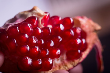 Fresh pomegranate macro picture on isolated black background