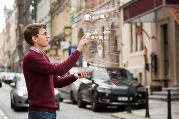 Augmented reality in marketing. Man with phone. Navigation on the projection of the display