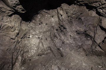 Underground abandoned ore mine shaft tunnel gallery face wall drill balst hole