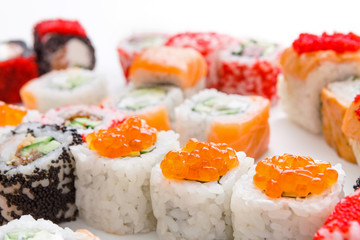 Closeup set of sushi rolls, maki with caviar on white background