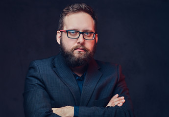 Fototapeta premium Serious plump male in eyeglasses over grey background.