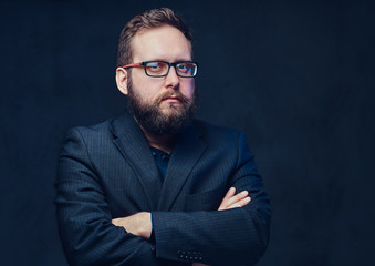 Serious plump male in eyeglasses over grey background.