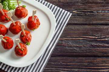 Plate with delicious meatballs on table