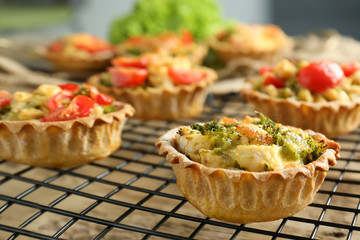 Delicious crispy tarts with broccoli on cooling rack