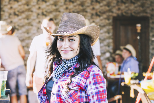Young woman beautiful cheerful portrait at a party in cowboy style