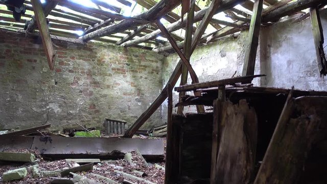 Chernobyl, Ukraine - 17th of June 2017: Visit to Zalesye village in Chernobyl zone - 4K Inside of collapsing house