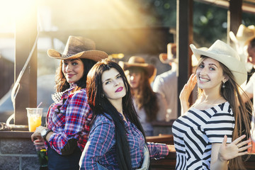 Women young beautiful sensual fun at a party with drinks together in cowboy style