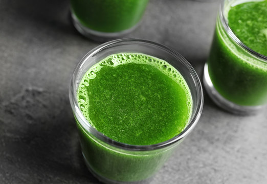 Shot of healthy wheat grass juice on grey background