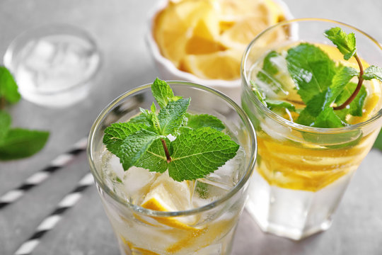 Glasses of cocktail with mint and lemon on table