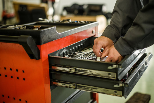 Car Mechanic Taking Out Tools From Toolbox.