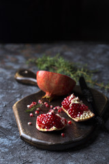 Red juice pomegranate on dark background