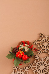 Wood snowflakes, creative wreath on beige background with copy space. Vertical.