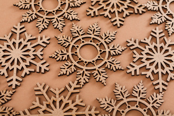 Wooden snowflakes pattern on beige background