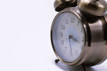 Brass alarm clock on white background