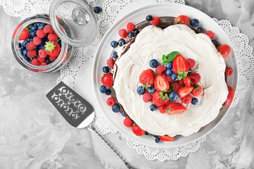 Delicious chocolate cake with berries on table
