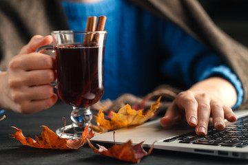 warm cup of hot mulled wine warming in the hands of a girl