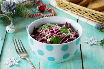 Homemade appetizer on a festive Christmas table. Salad with meat (liver pork), beetroot and fresh cucumber.