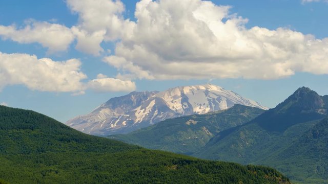 Ultra high definition 4k time lapse video of moving white clouds and blue sky with moving sun shadow over Mount St. Helens closeup 3840x2160