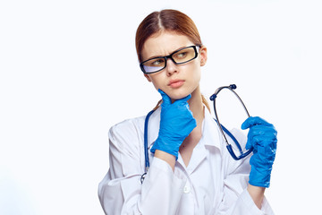 woman medical officer in uniform and glasses pondered over stethoscope