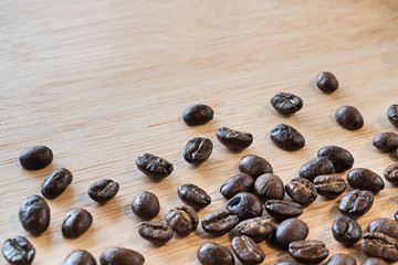 close up of Coffee beans on wood background, selective focus (detailed close-up shot)