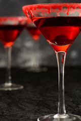 Halloween cocktail with bloody rim on the dark background
