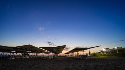 deckchairs on a beach by night