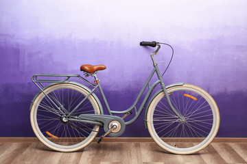 Fototapeta na wymiar Retro bicycle near color wall