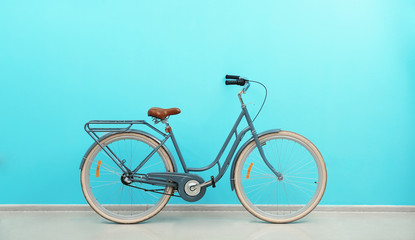 Retro bicycle near color wall