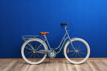 Retro bicycle near blue wall