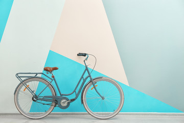 Retro bicycle near color wall