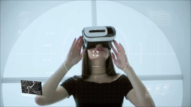 Young attractive Asian female uses futuristic virtual reality headset to access holographic touchscreen interface