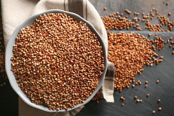 Raw buckwheat in bowl on table