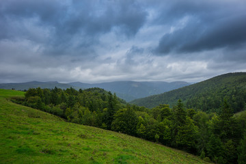 Fototapeta na wymiar France - Dramatic sky cloud formations over french forest and mountains in alsace