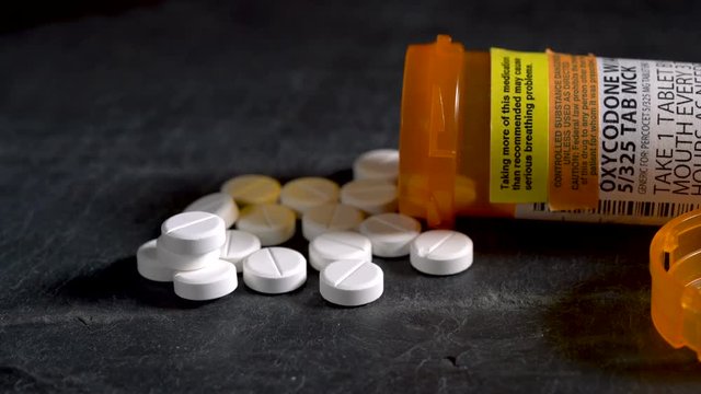 4K Macro video of Oxycodone Opioid tablets on slate table
