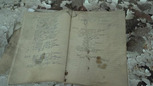 Chernobyl, Ukraine - 17th of June 2017: Visit to Zalesye village in Chernobyl zone - 4K Old journal on the table found in Zalesye village in Chernobyl Zone