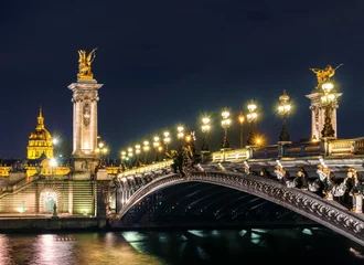 Photo sur Plexiglas Pont Alexandre III Paris, France - October 20, 2017: Night view to Alexander III bridge columns and Les Invalides on background. Copy space in sky.