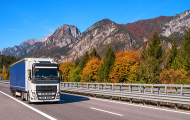 TYROL, AUSTRIA - October 14, 2017: A white blue truck on a high-speed mountain road.