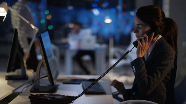  Business group working late in the office looking over company figures