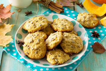 Breakfast table with pumpkin scones and milk on a kitchen wooden table.