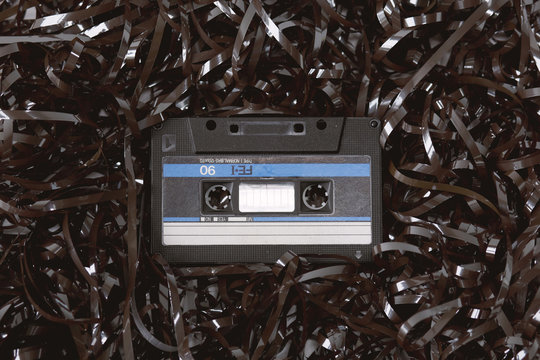 Old audio cassette on a bed of loose tape