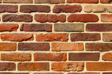 the wall is composed of bricks painted brown and orange paint