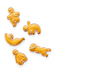 Gingerbread cookies in shape of yoga asanas on white background top view copyspace