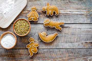 Make gluten free healthy food. Yoga asanas cookies near desk, flour and wheat on wooden background top view mock-up